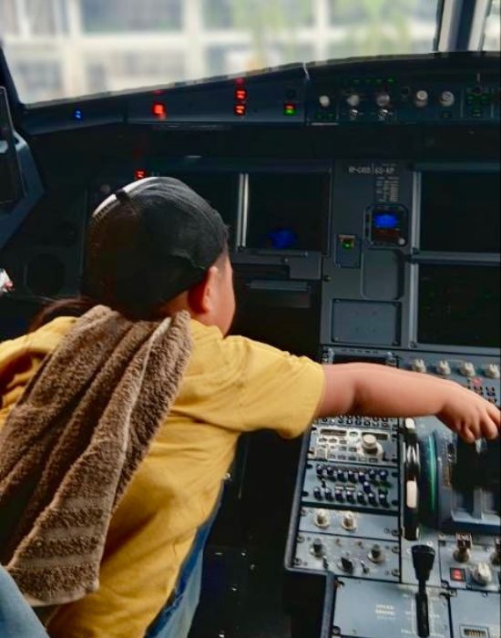 Aquil maneuvering the plane (pretend)