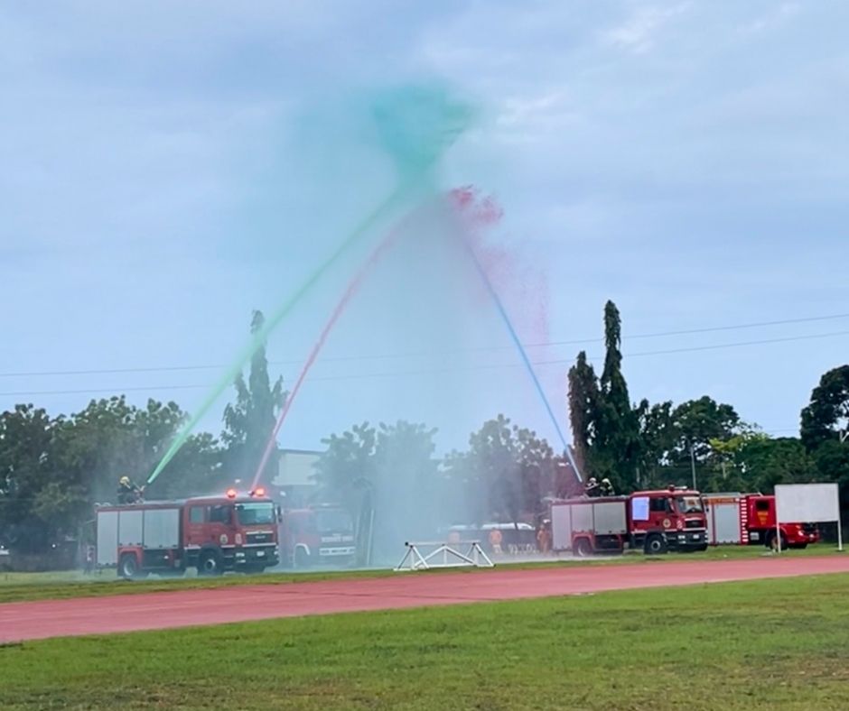 water arch created by fire trucks